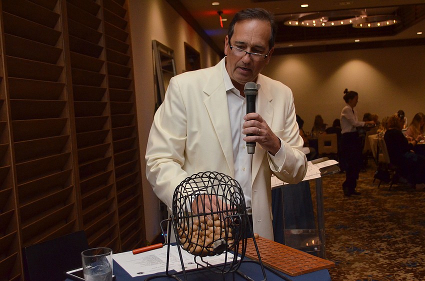 Auctioneer Adam Armbruster picks the first number/letter combination of the night.