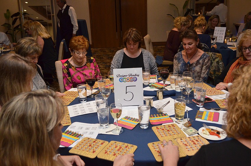 Guests at table 5 wait to see if Auctioneer Adam Armbruster will call a winning number/letter combination.