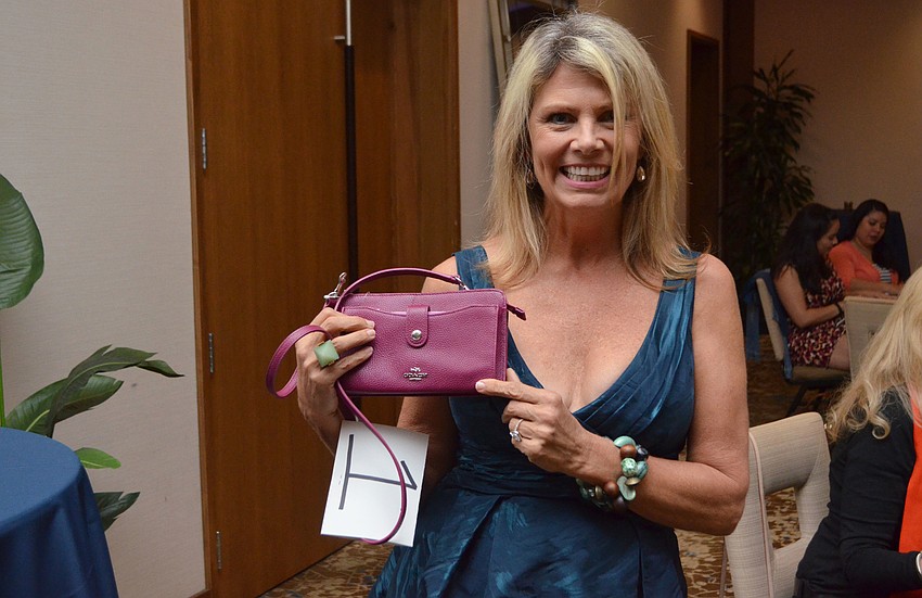 Bingo winner Julie Johnson was awarded with a magenta Coach bag.
