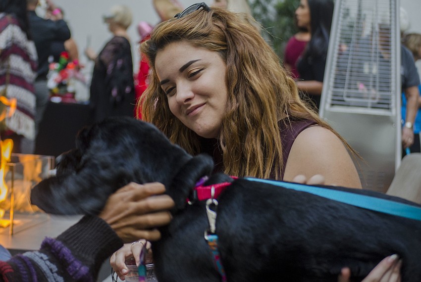 Becca Duchanan pets one of the animals featured during the Smoochy Poochy Yappy Hour.