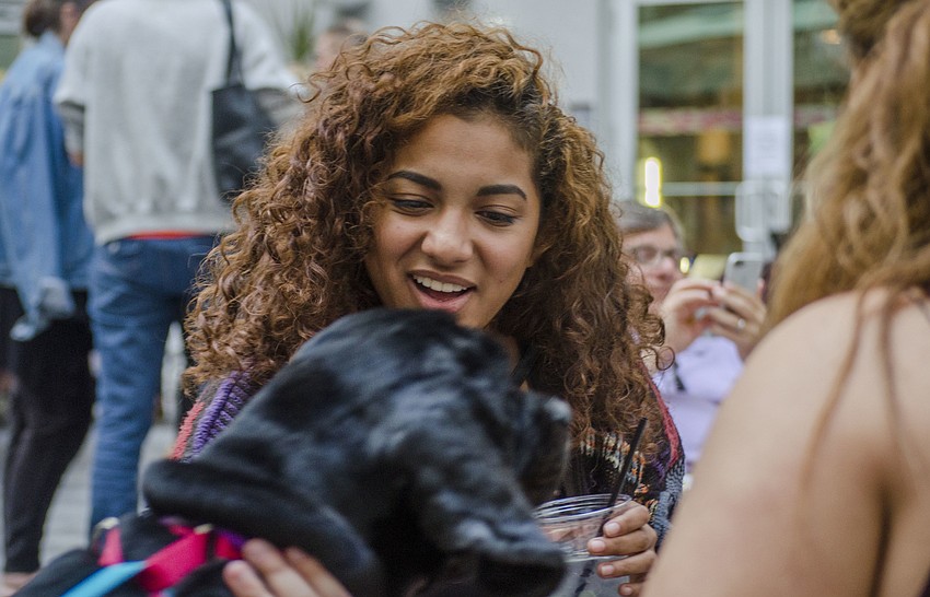 Cindy Almonte pets one of the animals featured during the Smoochy Poochy Yappy Hour.