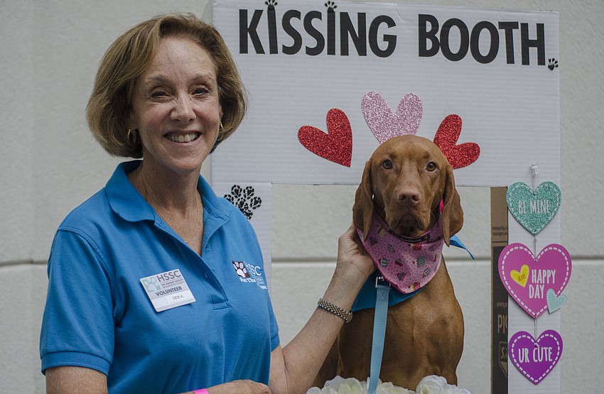 Deb Kabinoff poses with a Humane Society therapy dog Gracie.