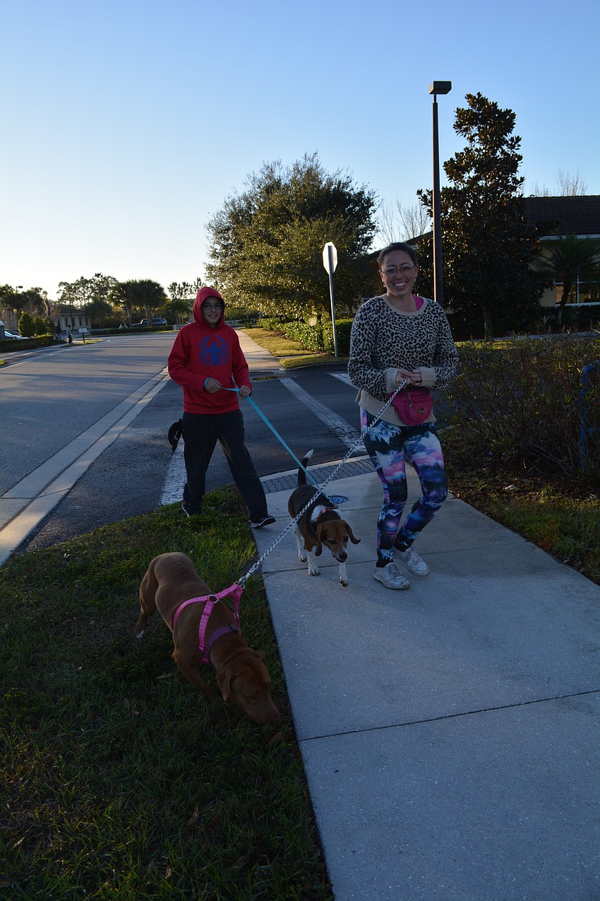 Tiffany Kaperna walks Minnie Mouse, while Skyler Vargas, walks Bo. 