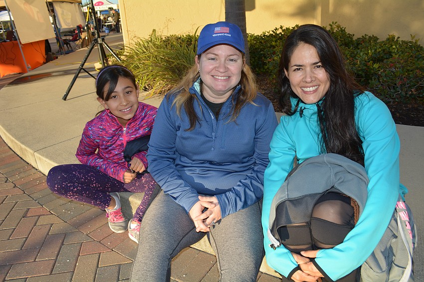 Ariana Barreiro, Patty Yero and Nathalia Escamilla, of Lakewood Ranch, watch for friends to finish the run.