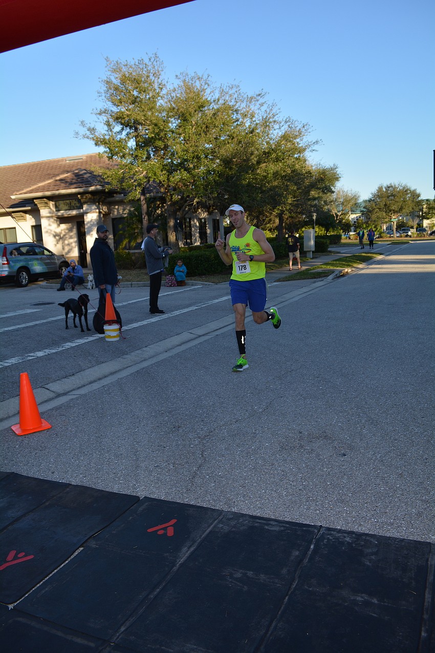 Barrington Ridge resident Corey Peyerk is the first to finish the race, which he ends in under 18 minutes.