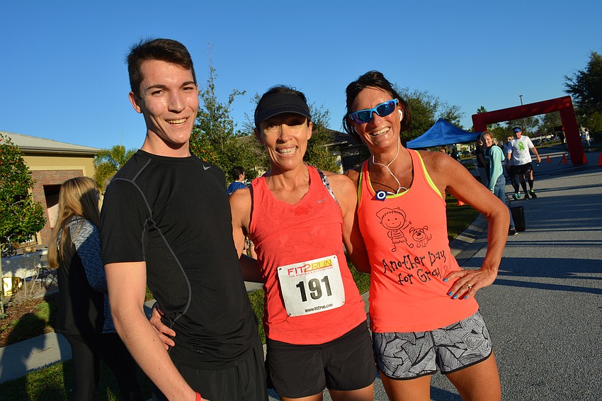 Lakewood Ranch'  s Sebastian and Fernanda Scalera join  runner Jen Tullio after running the 5K.