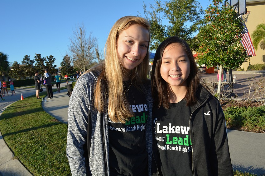 Meg Caron and Kelsey Le direct runners to post-race food and drink.