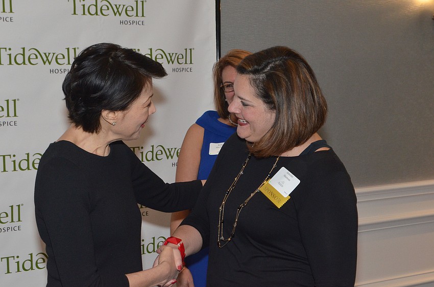 Ann Curry shakes Jennifer Sherman’s hand at the meet-and-greet in the St. Armands Jr. Ballroom at The Ritz-Carlton, Sarasota on Feb. 10.
