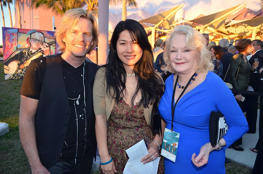 Eric Waugh, winner of his paintings Jaclyn Brunckhorst and Monica Van Buskirk, president of the Van Wezel Foundation
