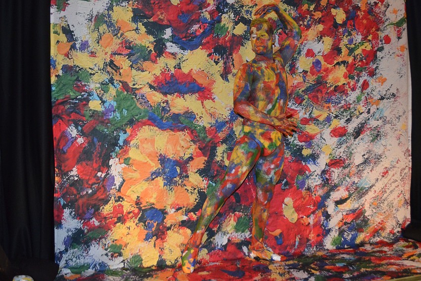 Models covered in paint blended in with three colorful paintings, moving ever so slightly every couple minutes to show guests that they were there.