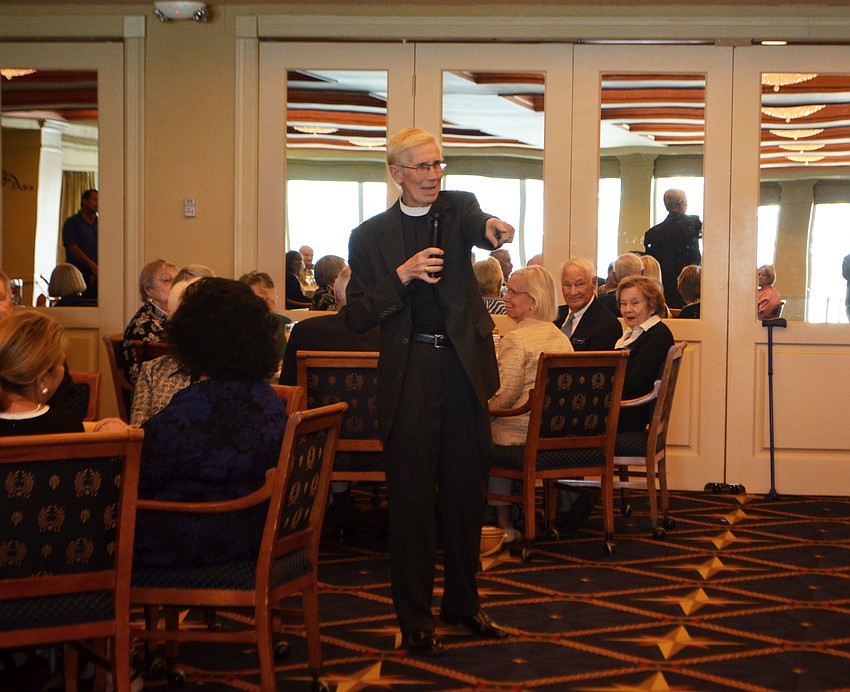 The Rev. David Danner announces which tables can help themselves to the brunch buffet first.