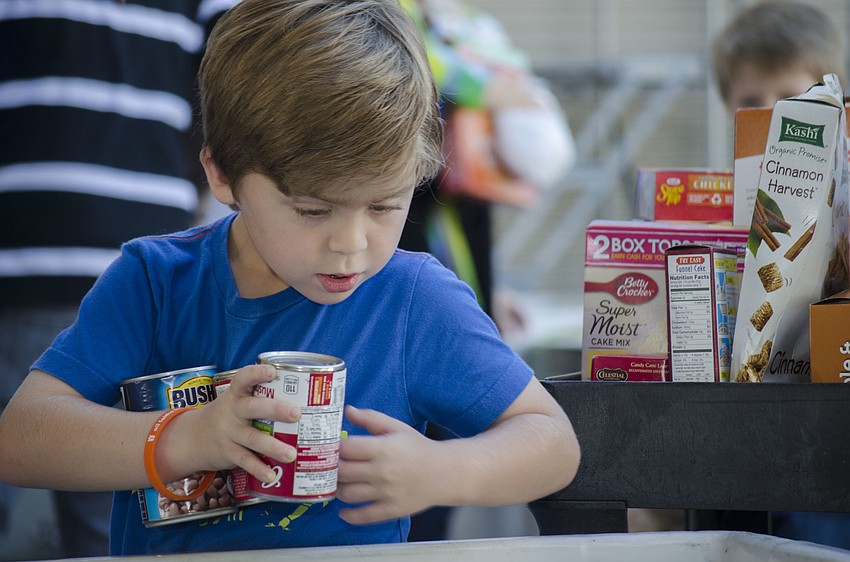 Skate Segal sorts cans at All Faith’s Food Bank.