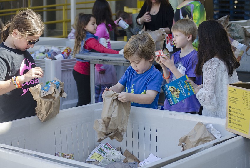 Children sort food at All Faith’s Food Bank as a part of Temple Sinai’s Mitzvah Day.