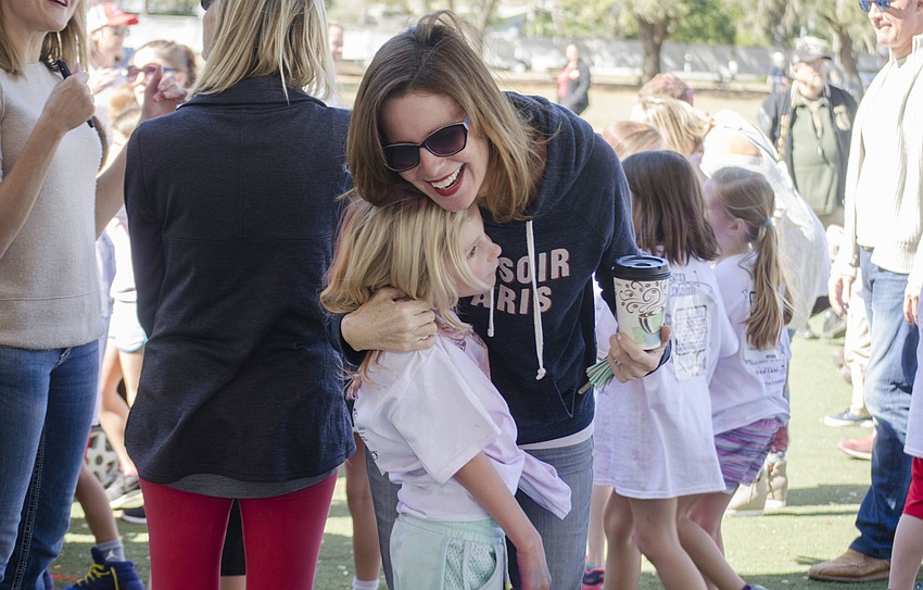 Beth Scheiderer hugs Sinclaire Scheiderer after the jog-a-thon