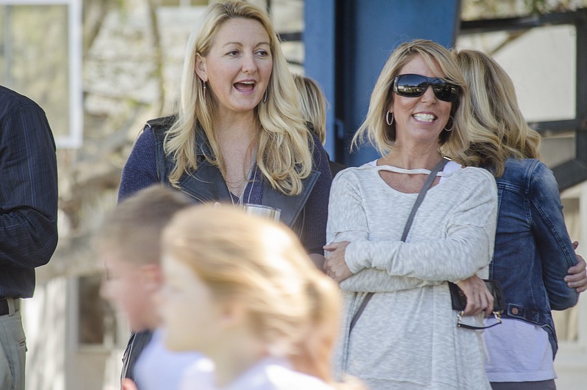 Kim Rusek and Tess Evanoff cheer on the students.