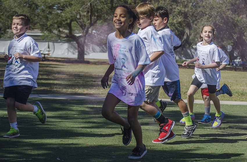 Students ran through clouds of colored chalk at the Southside Jog-a-thon Color Run.
