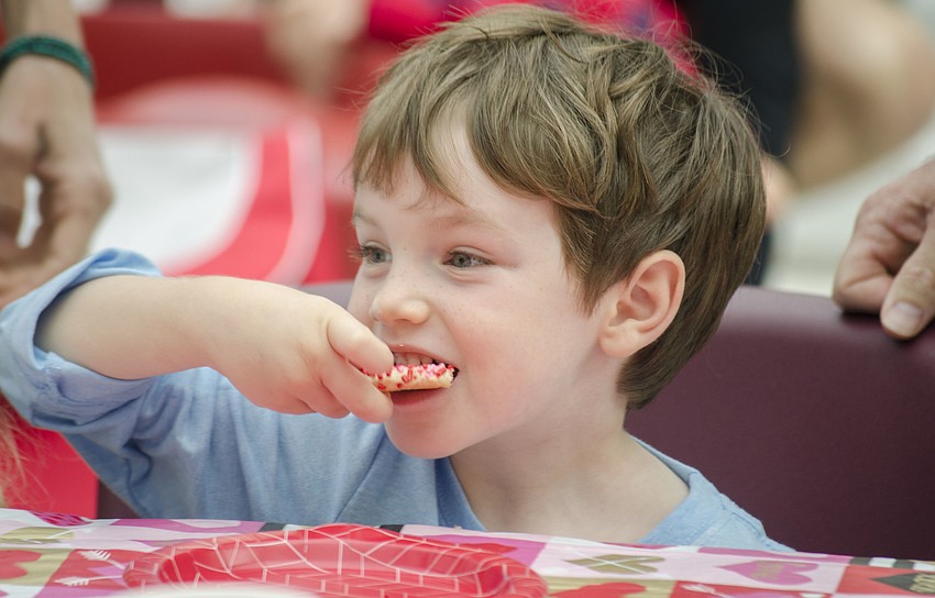 Garrett Barsell eats a cookie at the First Presbyterian Preschool Valentine'  s Day Tea.