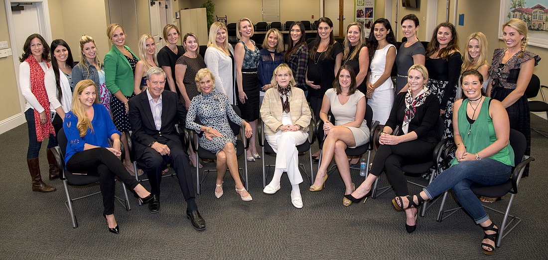 Members of Designing Daughters (standing) with Designing Daughters and Roskamp Foundation leaders (seated) â€” Photo by Cliff Roles