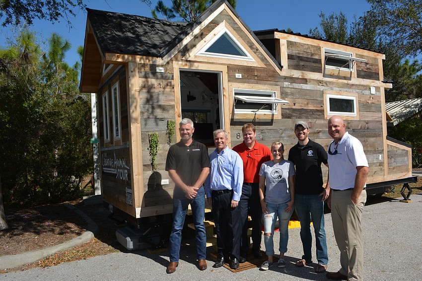 Willis Smith'  s Brett Raymaker, David Sessions and John LaCivita, Wild Kingdom host Stephanie Arne, wildlife artist Tim Davison and Willis Smith'  s David Otterness enjoy the Tiny House.