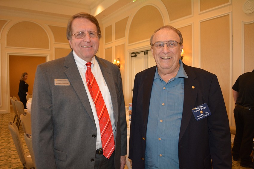 Ronald Engstrom, of Northwestern Mutual, chats with Rotarian Preston Olinger. Northwestern Mutual is a sponsor of the Rotary Club'    s Wine Festival.