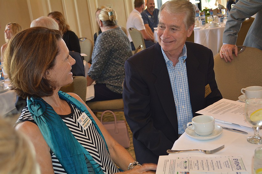 Patty Seidensticker, of Bemer Group, talks with Rotarian Ted Lindenberg.