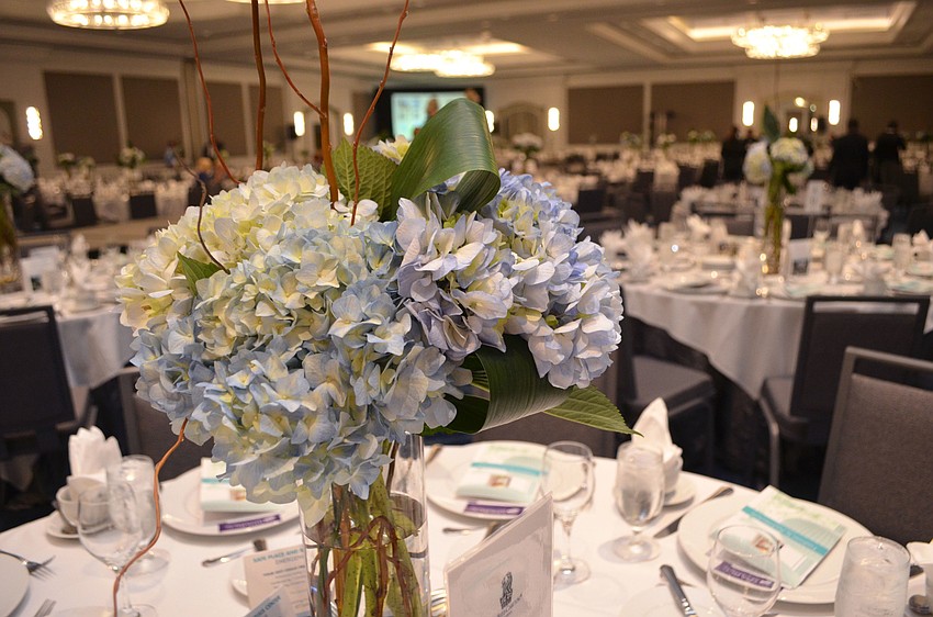 There was a plastic bag hidden under one of the plates at every table to decide who would be the lucky winner of the floral centerpiece.