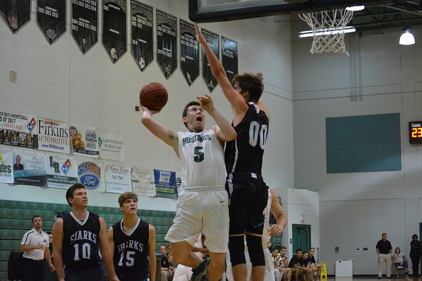 Sam Hester takes contact on a drive to the basket.