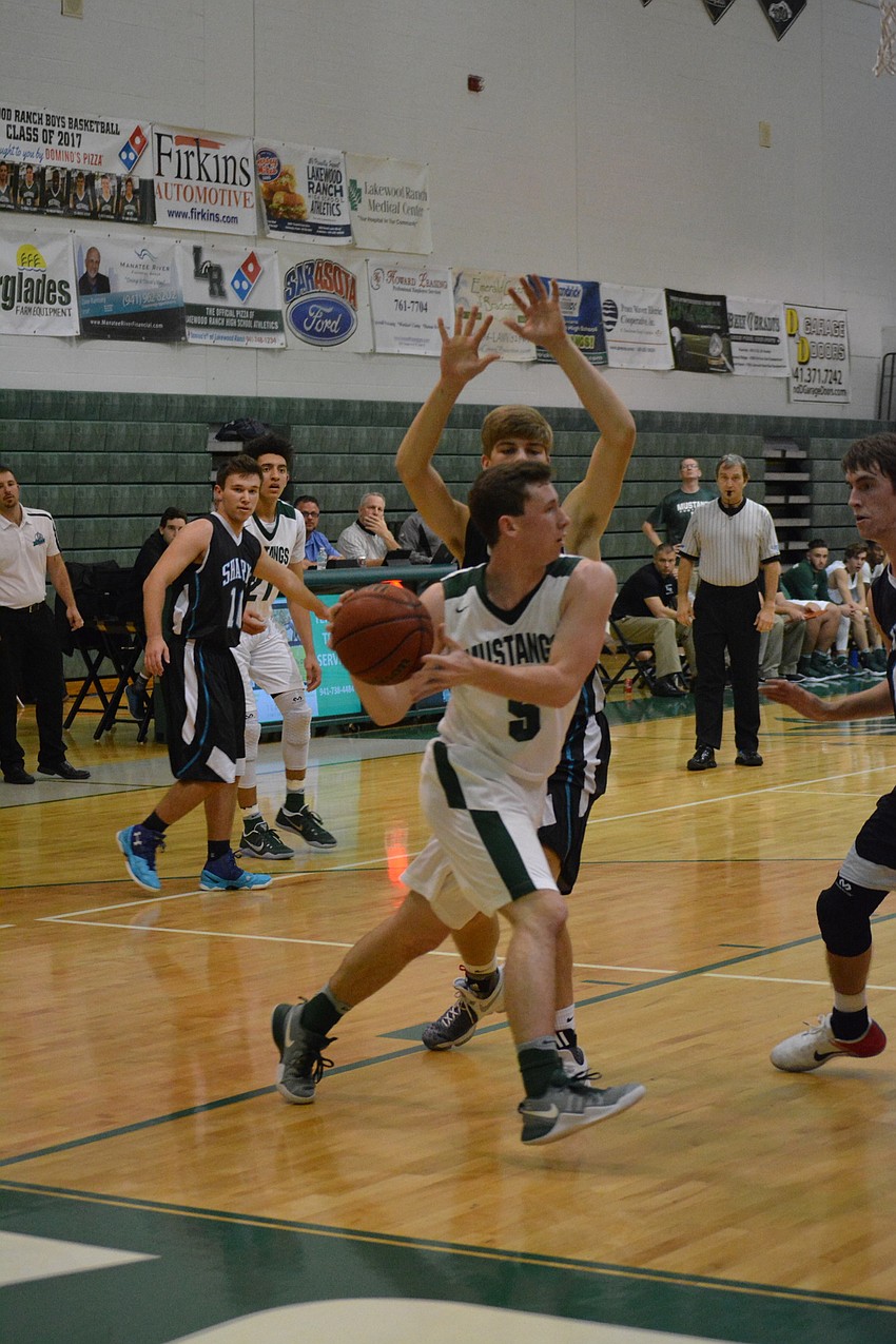 Sam Hester looks for an open teammate on the baseline.