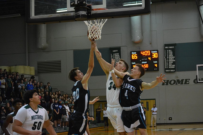 Jack Kelley beats two defenders to the hoop.