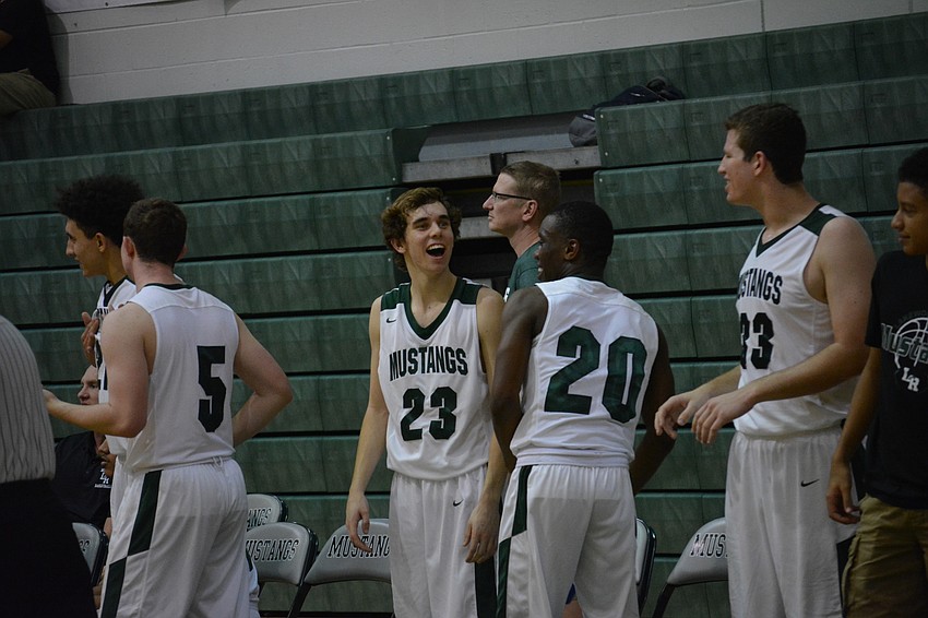 The bench laughs as the game comes to a close.