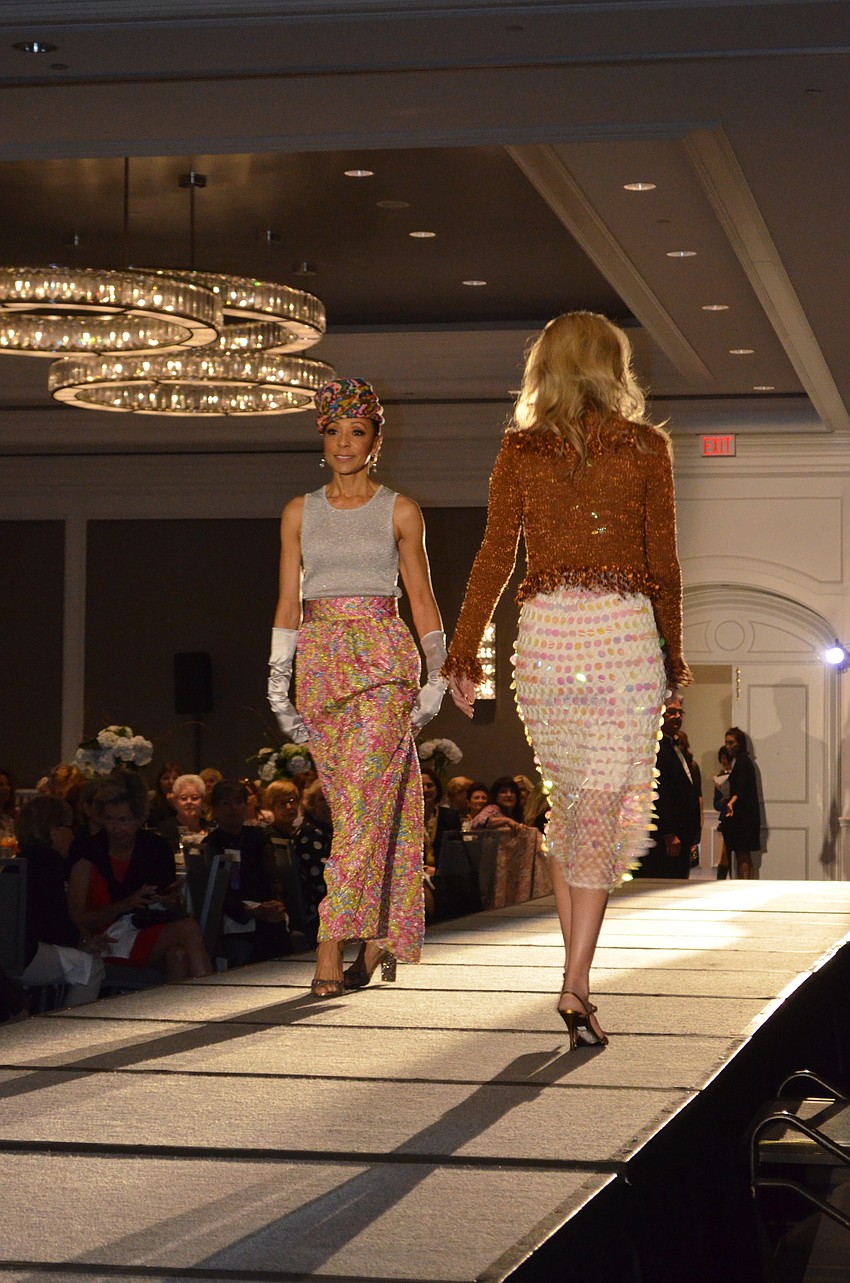 Kathleen Collins passes Erin Duggan on the runway during the fashion show at The Ritz-Carlton, Sarasota on Feb. 16.