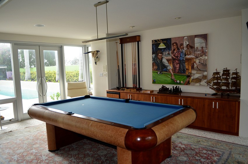 A billiards room is to the left of Rooks’ front door. The room leads out to the pool deck.