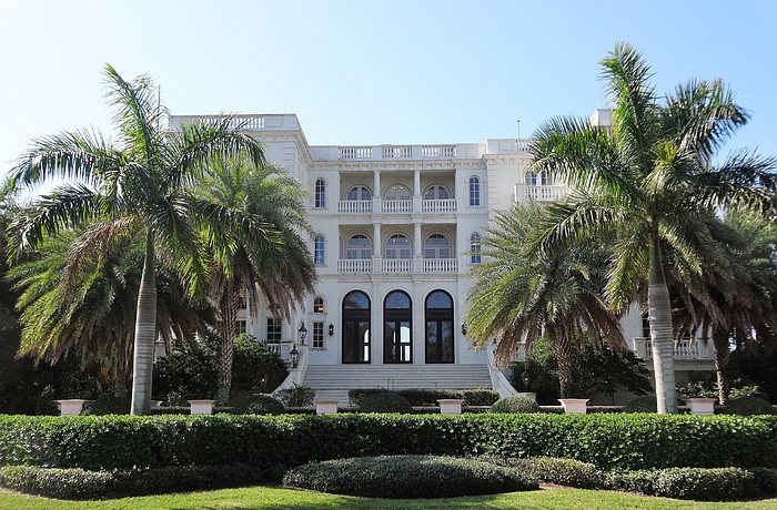 The Venetian-inspired estate features a three-story main house.