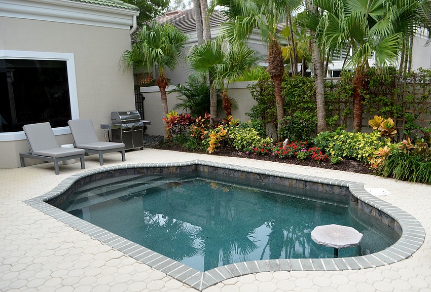 Between the guest house and main house is a pool and deck.