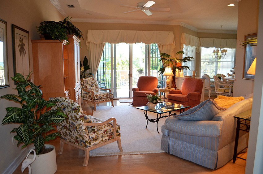 The living room leads out to a deck overlooking the pool.