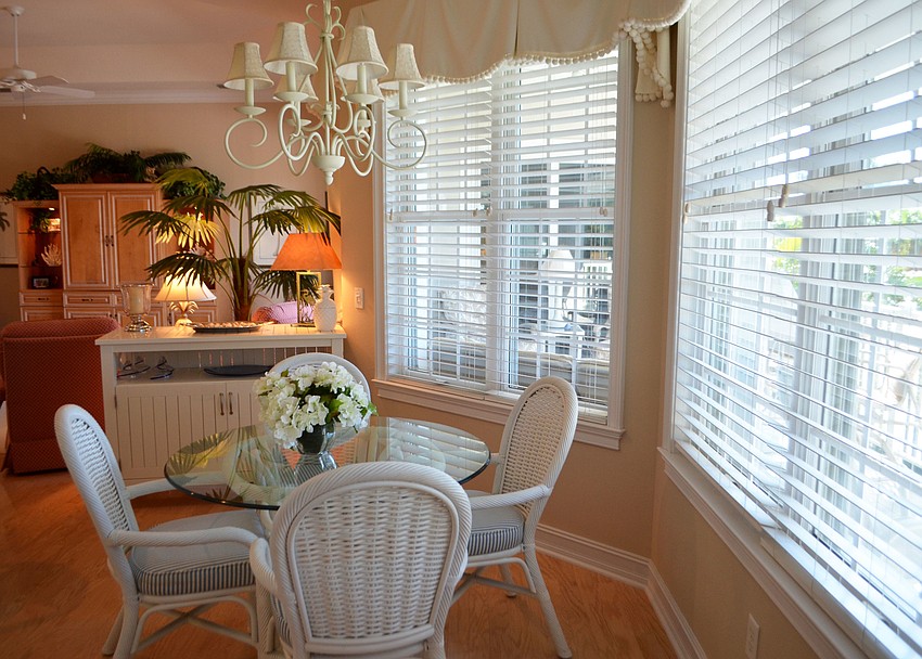 The kitchen table looks out into the backyard and pool area.