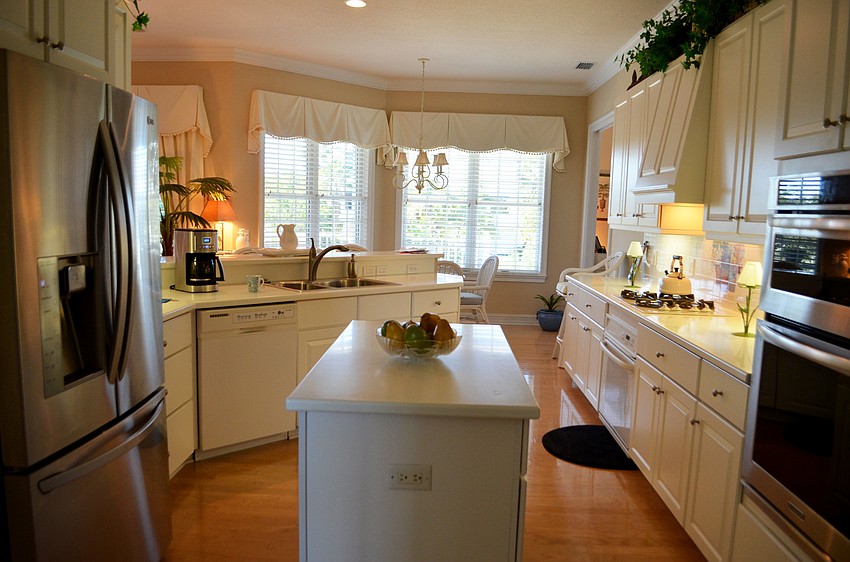 The kitchen leads to a den that could be used as a guest bedroom.