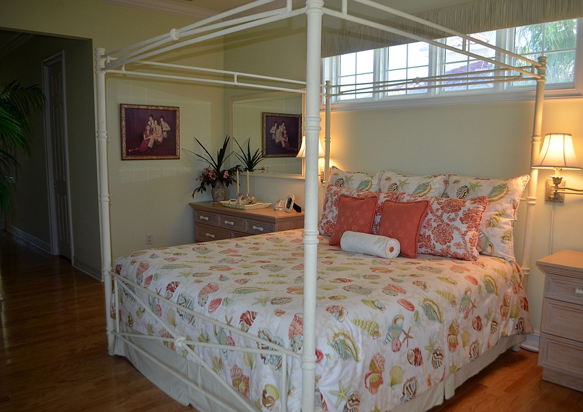 The master bedroom features light walls with color accents, like the bedding.