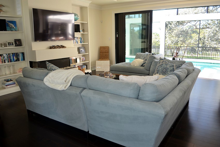 The living room gives off a sea vibe with blue tones spread throughout.