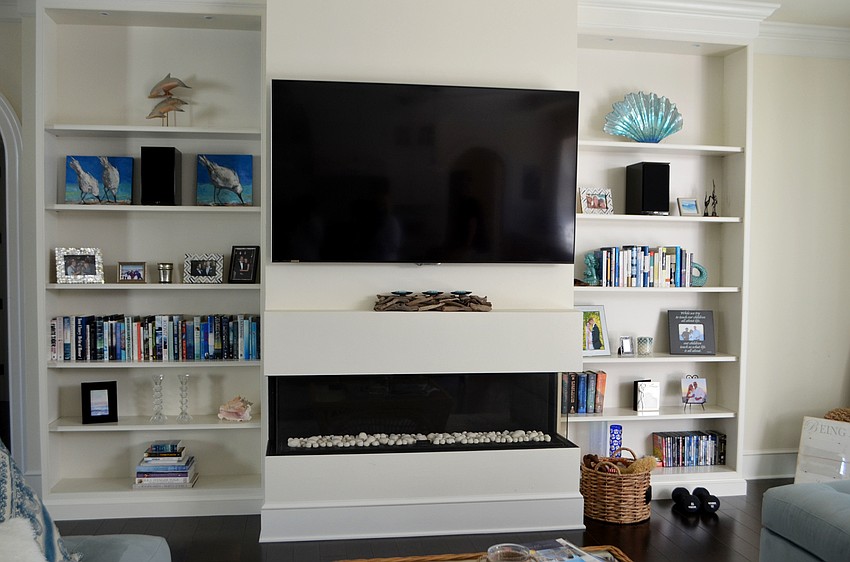 Howard only puts books that have blue colors on the cover on the shelves of the entertainment center.