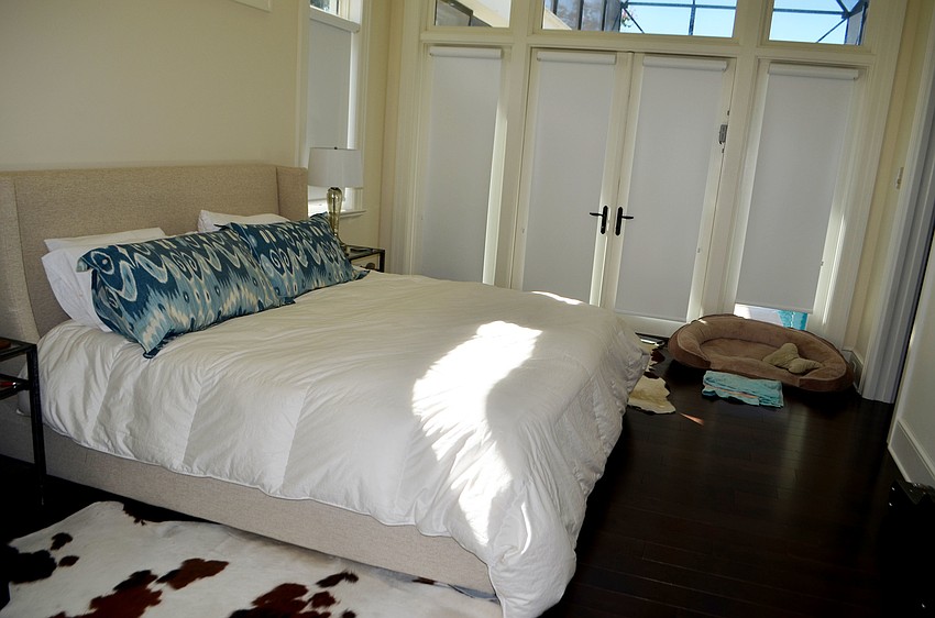 The master bedroom has doors that open to the pool deck.