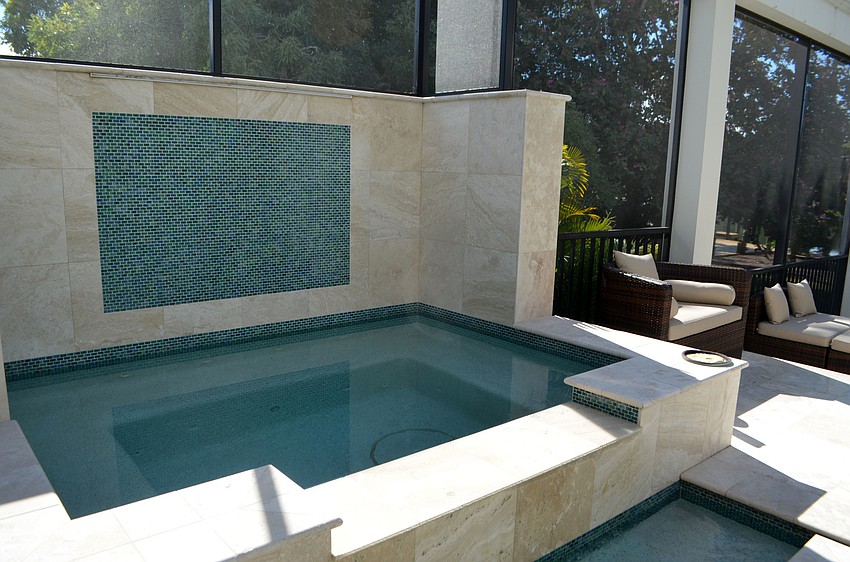 A hot tub is connected to the main pool.