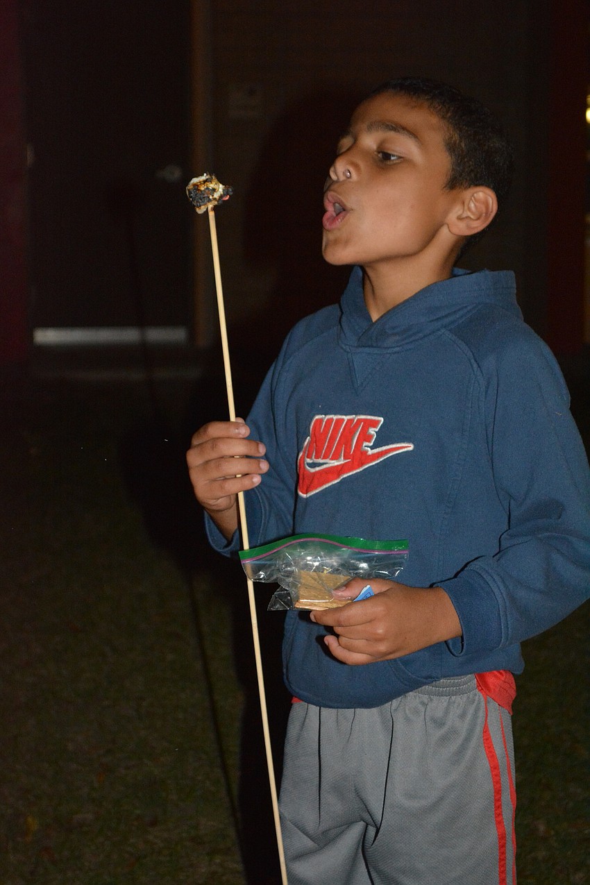 Jordan Banks, 9, blows out his fire-stricken marshmallow.