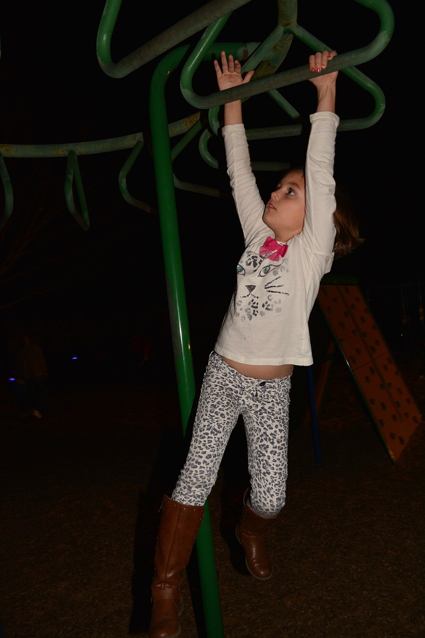 Savannnah Hoffman, 7, is a pro on the monkey bars, even in the dark.