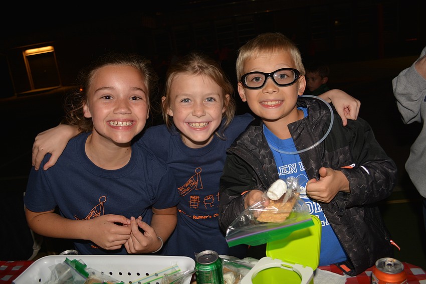 Fourth-graders Ella Pramuka, Claire Femenia and Benjamin Hanson sell pre-packaged s'  more packets.