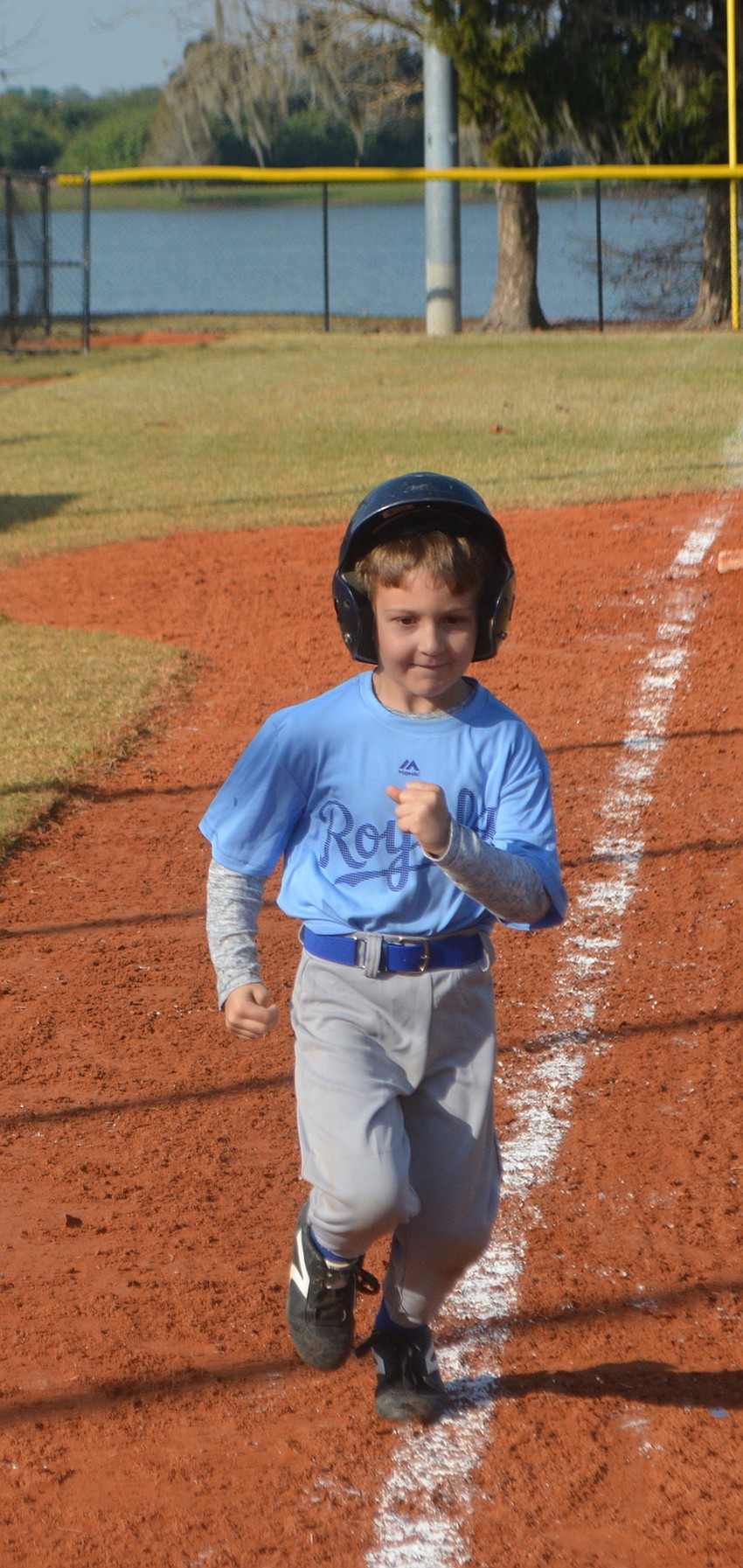 The Royals'    Jacob Guarino chugs toward home plate on opening day.