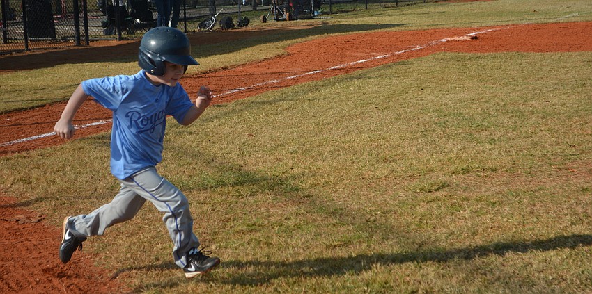 Nolan Lane of the Royals runs toward first after connecting.