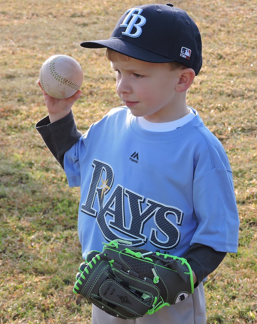Cole Hay of the Rays'    T-Ball team warms up for the opener.