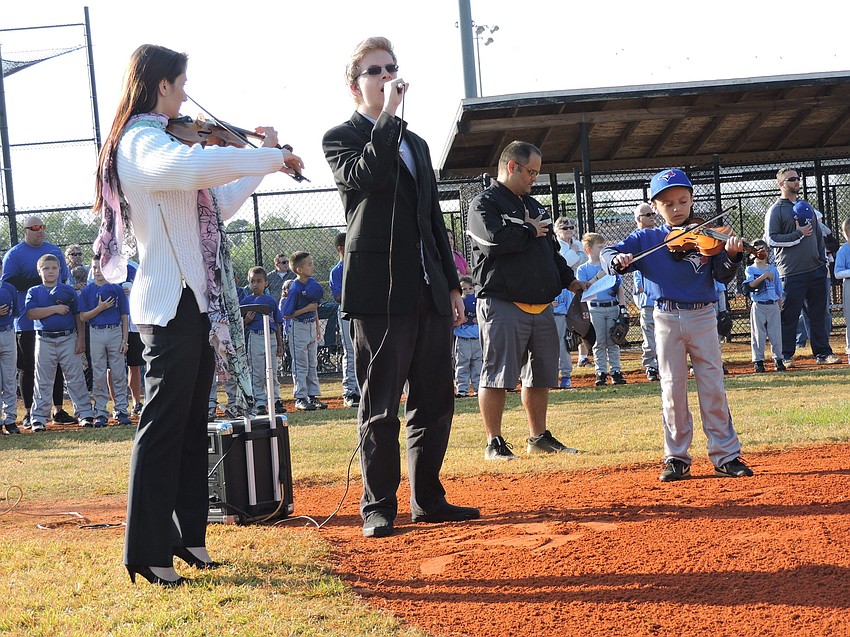 The Venice Symphony'   s Karissa Ratzenboeck, Sarasota Youth Opera'   s Leeson Fallon and Sarasota Youth Orchestra'   s Brody Rose play the Star Spangled Banner.