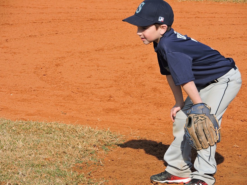 The Mariners'    Logan Yates gets ready for the pitch to home plate.